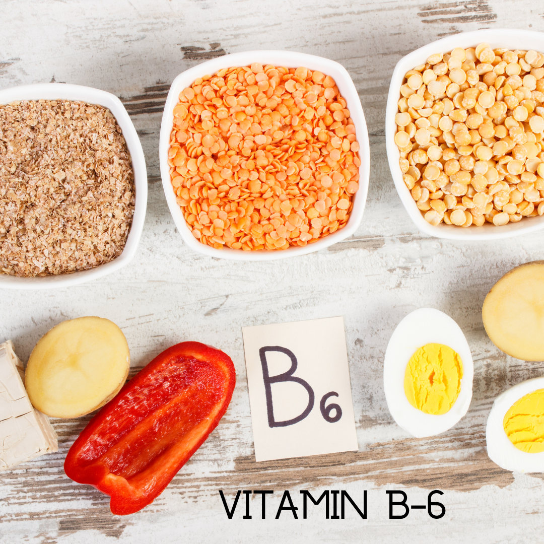 Bowls of lentils, grains, and vegetables on a wooden surface with a focus on vitamin B6.